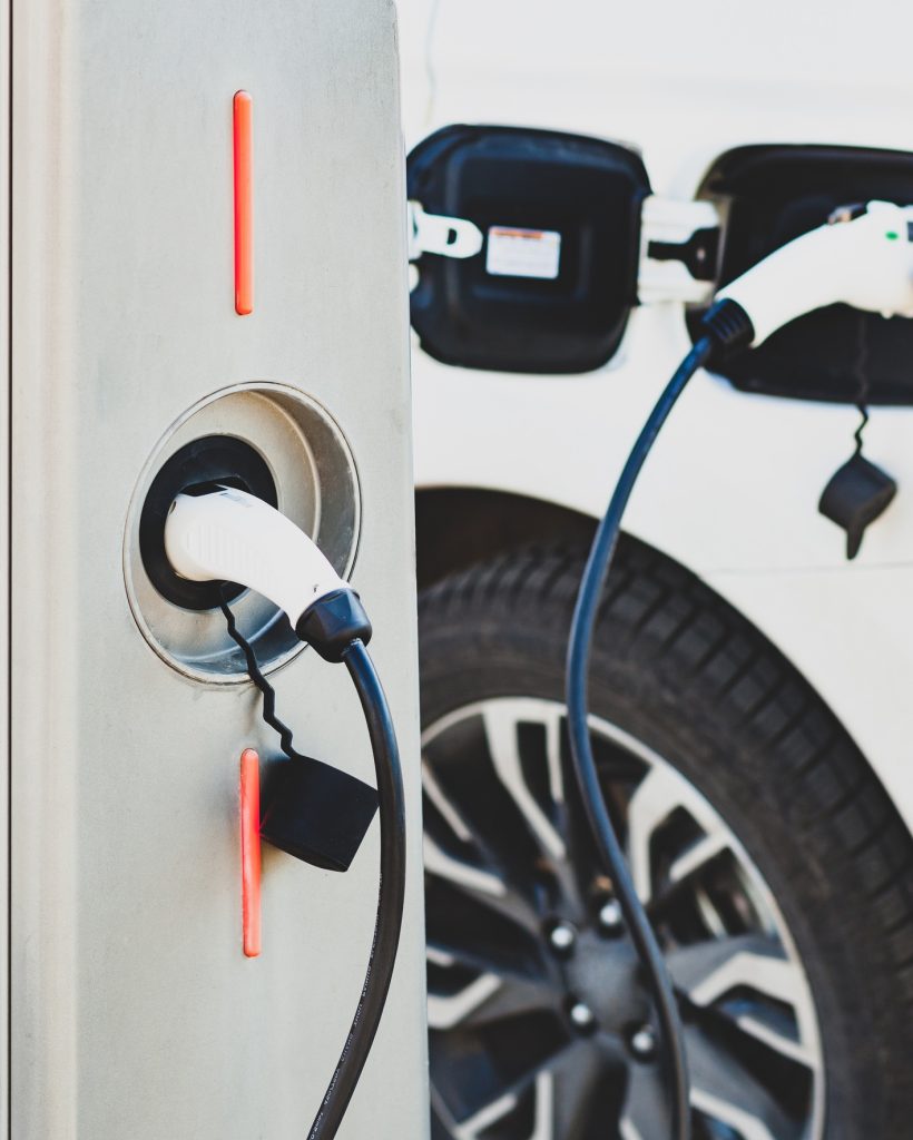 The electric car charger plugged in to the socket.The modern electric car charging the battery.